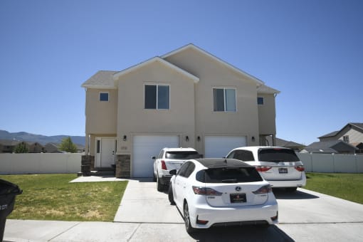 two cars parked in front of a house