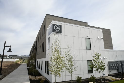 a large white building with a logo on the side of it