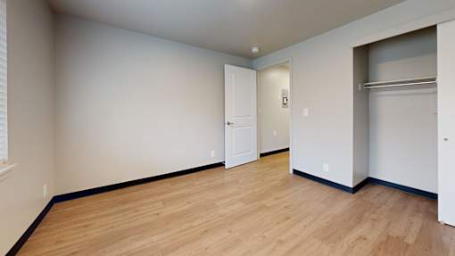 A room with a wooden floor and white walls.