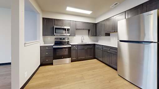 A modern kitchen with a stainless steel refrigerator.