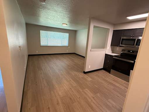 A kitchen area with a microwave, oven, and cabinets.