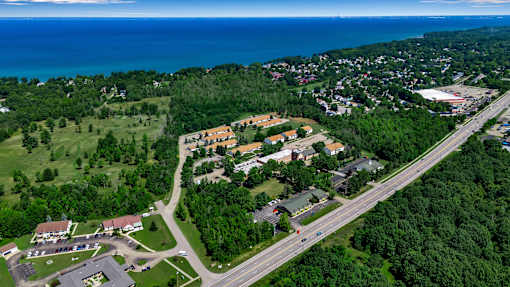 A bird's eye view of a residential area with a road running through it.