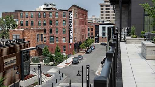 A view of a street with cars and buildings.