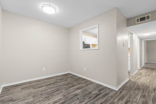 A room with a wooden floor and a window.