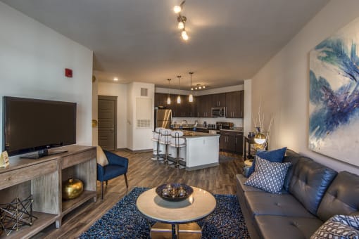 a living room and kitchen with a couch and a table