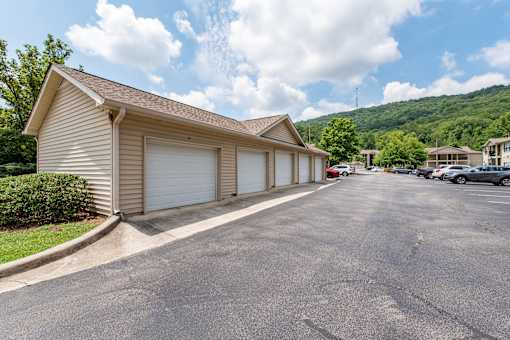 A residential area with a house and a parking lot.