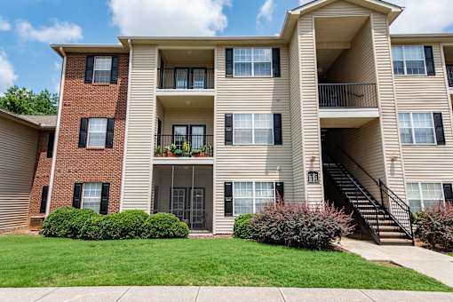 A large apartment building with a balcony on the second floor.