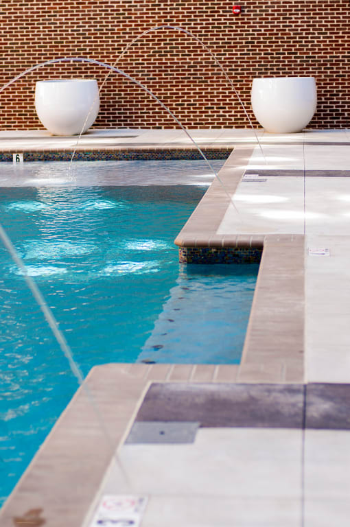 two white fountains in a swimming pool