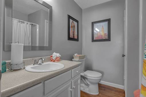 A bathroom with a white toilet and a white sink.