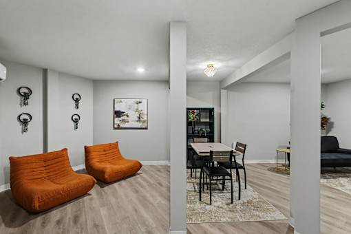 A living room with a dining table and chairs. at Mayfair Apartments, Missouri