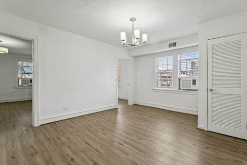 A room with wooden floors and white walls at Shipyard Shores Apartments, Virginia