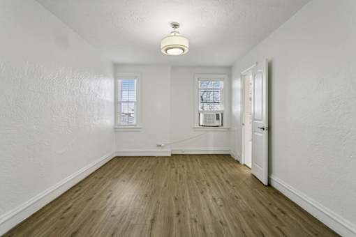 A room with wooden floors and white walls at Shipyard Shores Apartments, Apartments, Newport News, VA