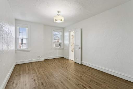 A room with wooden floors and white walls at Shipyard Shores Apartments, Newport News, 23607