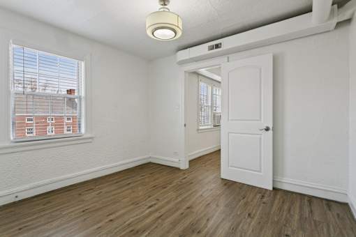 A room with a white door and a window with blinds at Shipyard Shores Apartments, Newport News, VA, 23607