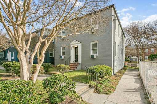 A grey house with a tree in front of it at Shipyard Shores Apartments, Newport News, 23607