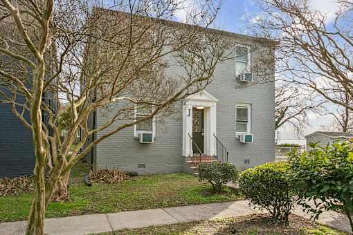 A grey house with a front yard and a bare tree at Shipyard Shores Apartments, Newport News, Virginia