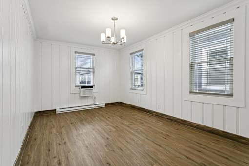 A room with wooden floors and white walls at Shipyard Shores Apartments, Newport News