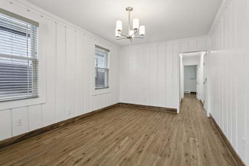 A room with wooden floors and white walls at Shipyard Shores Apartments, Virginia, 23607