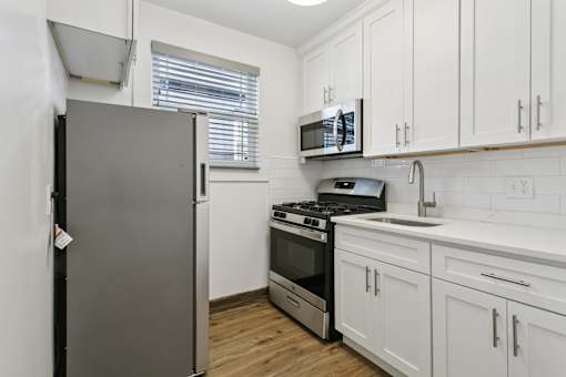 A kitchen with a refrigerator, stove, oven, and microwave at Shipyard Shores Apartments, Apartments, Newport News, VA