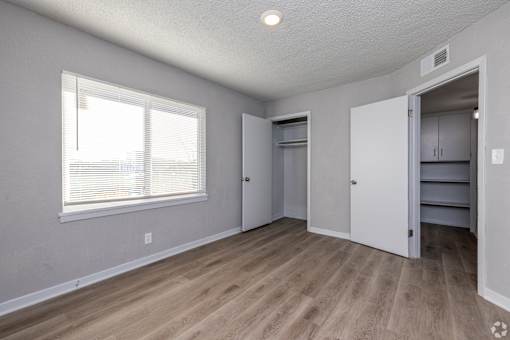 A room with a window and a door leading to another room. at Blacklark Apartments, Kansas City