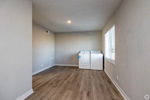 A room with a white wall and a window with a white curtain. at Blacklark Apartments, Kansas City, Kansas