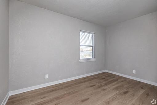 A room with a window and wooden flooring. at Blacklark Apartments, Kansas City, Kansas
