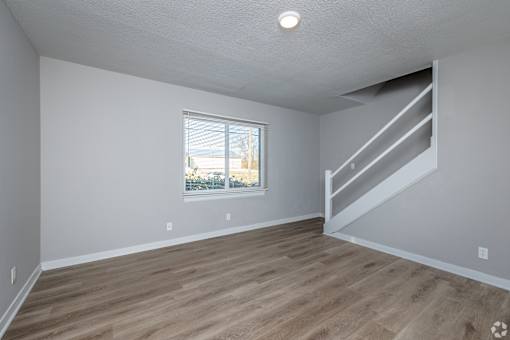 A room with wooden flooring and a window. at Blacklark Apartments, Kansas