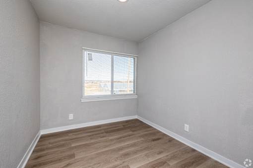 A room with a window and wooden flooring. at Blacklark Apartments, Kansas City, Kansas