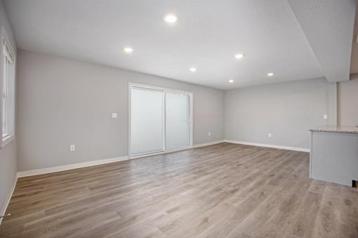 A room with wooden flooring and a bar counter.at Palisades Apartments, Kansas City Missouri