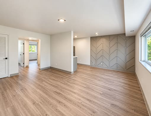 Spacious living room with chevron accent wall at The Wyman Hills AHR LLC Apartments, Maryland, 21211