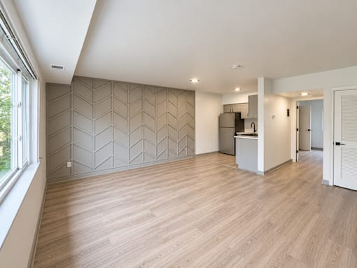 Open concept living area with modern kitchen at The Wyman Hills AHR LLC Apartments, Baltimore, MD 21211