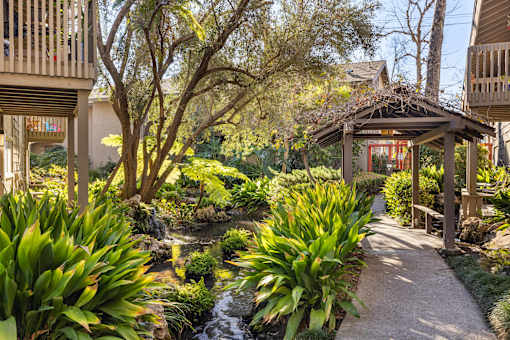 A garden with a gazebo and a stream running through it at The Aspens Fairhaven, Santa Ana, 92705