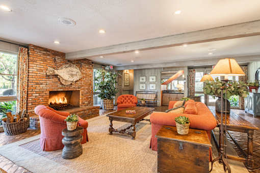 A clubhouse living room with a fireplace and a couch at The Aspens Fairhaven, Santa Ana, 92705