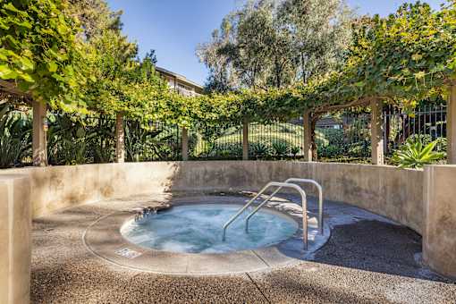 A hot tub sits in the middle of a garden at The Aspens Fairhaven, Santa Ana, 92705