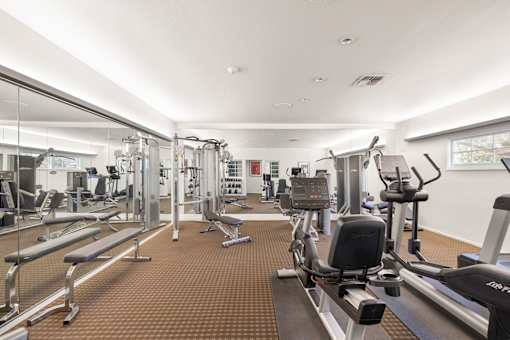 A fitness studio with treadmills, weights, and other exercise equipment at The Aspens South Coast, California, 92504