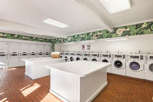 A laundry room with a white counter and washing machines at The Aspens Fairhaven, Santa Ana, 92705