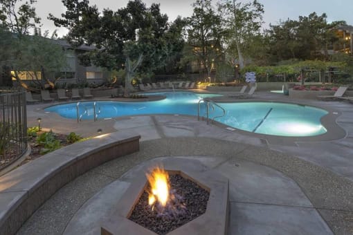 a swimming pool with a fire pit