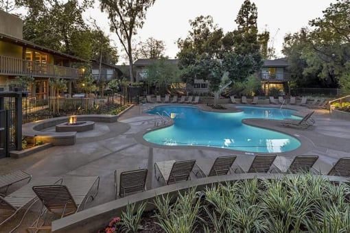 a large swimming pool with chairs around it