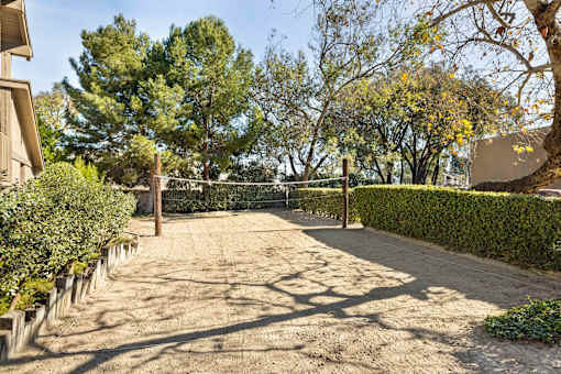 A sand volleyball court surrounded by hedges at The Aspens South Coast, California, 92504