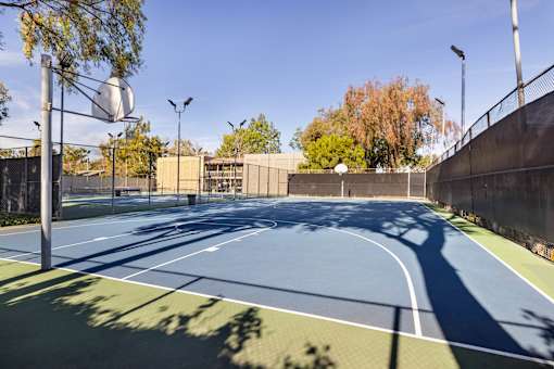 A basketball court with a blue surface and white lines at The Aspens South Coast, California, 92504