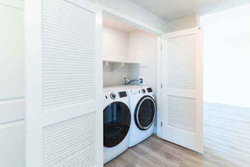 A laundry room with a washer and dryer in it.