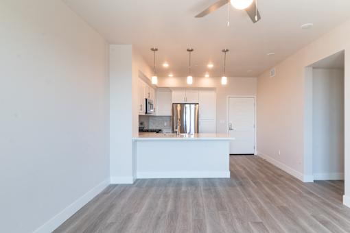 A kitchen with a white island and a fan.