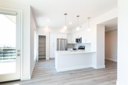A white reception desk with a white counter and a white chair.