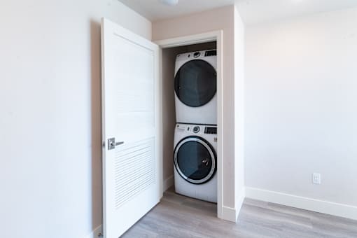 A washer and dryer are tucked into a small space in a home.