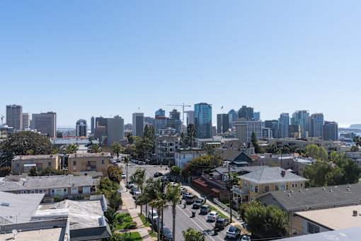A cityscape with buildings and cars on the street.