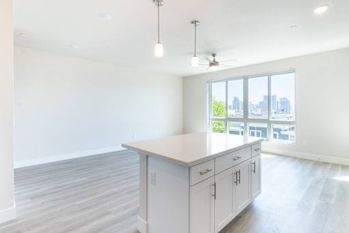 A kitchen with white cabinets and a large island.