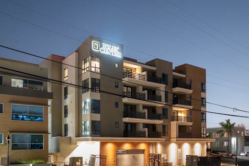 A building with a sign that says "BOULEVARD CENTER" is shown at dusk.