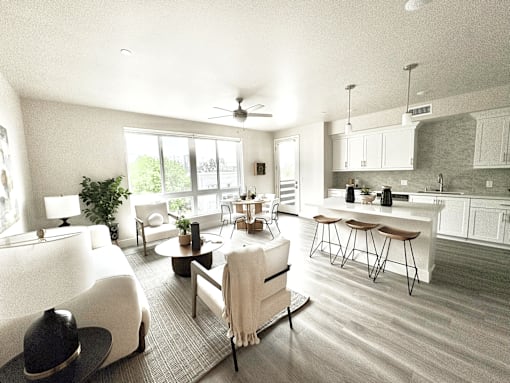 A modern open plan living and kitchen area with a dining table and chairs.