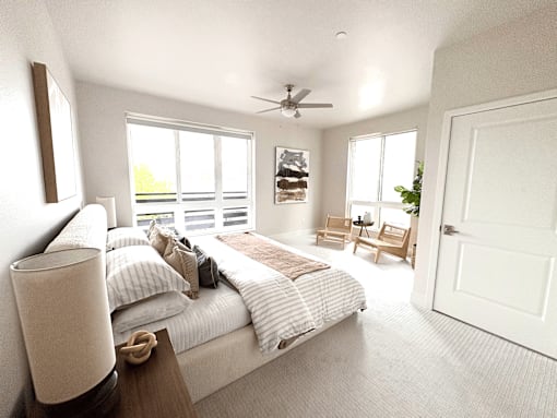 A bedroom with a large bed and a ceiling fan.