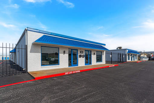 A fire station with a blue roof and white walls.